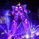 Musicians perform at the base of a life-sized Gundam statue in Tokyo.